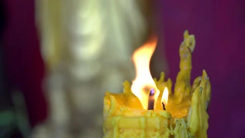 A candle burns in the Budi temple Stock Footage 222598124