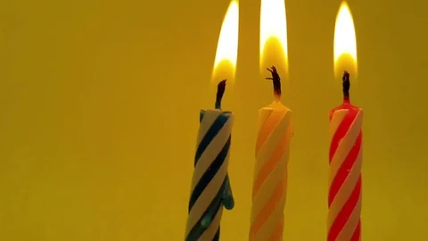 Candle burns on a colored background slow motion Stock Footage 115826851