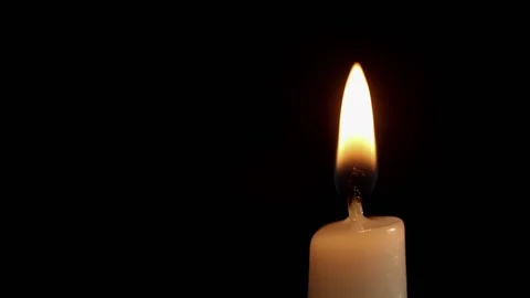 The candle burns in the dark on a black background Stock Footage 196999388