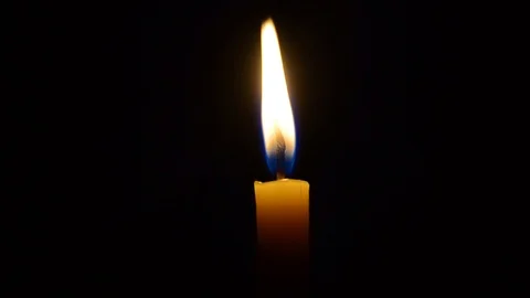 A candle burns in the dark Stock Footage 97759521
