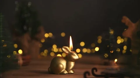 A candle burns in the form of a rabbit, a symbol of 2023 Stock Footage 222003737