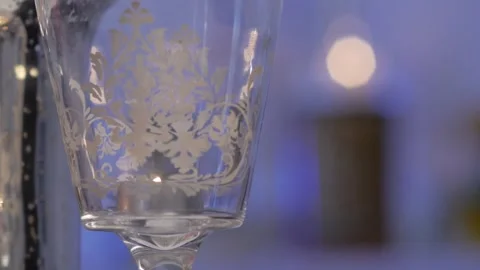 The candle burns inside a glass container with luxurious engravings Stock Footage 244315439
