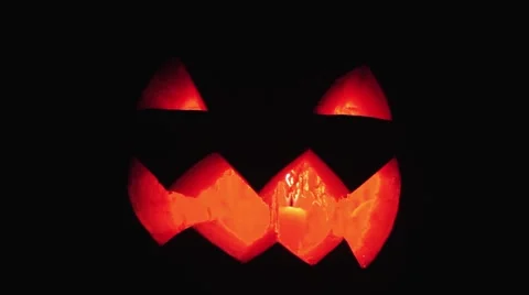 Candle burns inside jack o lantern on a halloween close up shot Stock Footage 68176446
