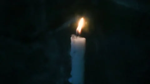 A candle burns in the rain Stock Footage 140455137