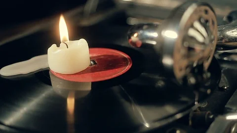The candle burns on a rotating vinyl record Stock Footage 95394657