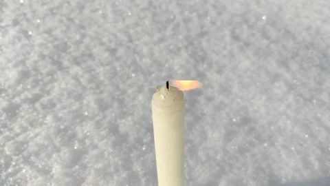 A candle burns in the snow 2 Stock Footage 327546771