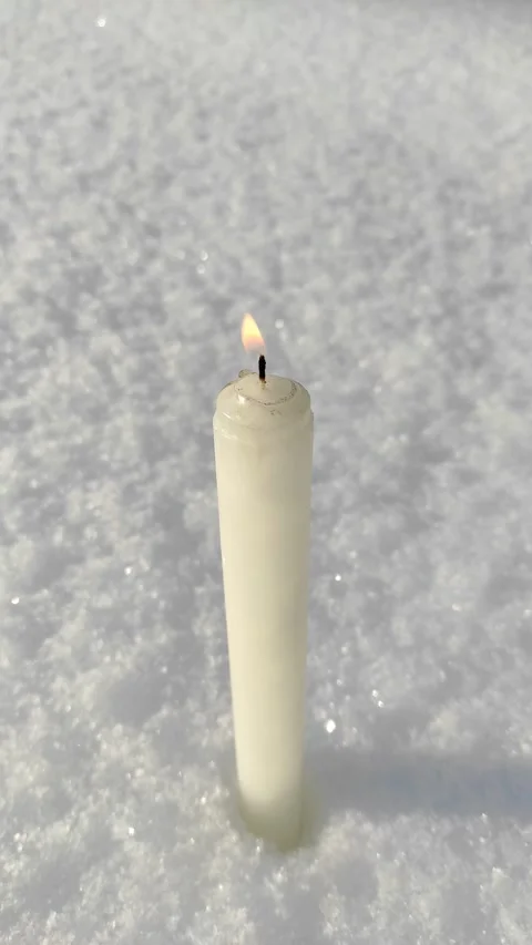 A candle burns in the snow 3 Stock Footage 327546772