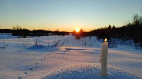 A candle burns at sunset 2 Stock Footage 327930270