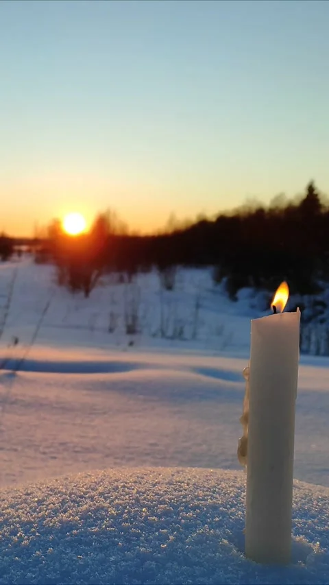 A candle burns at sunset 3 Stock Footage 327930119