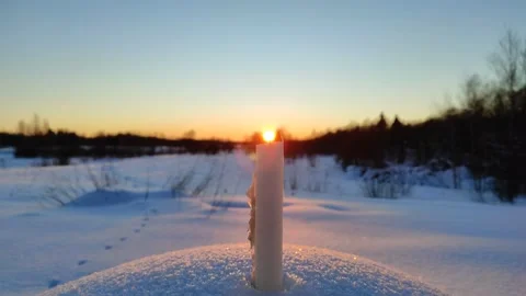 A candle burns at sunset 4 Stock Footage 327930297