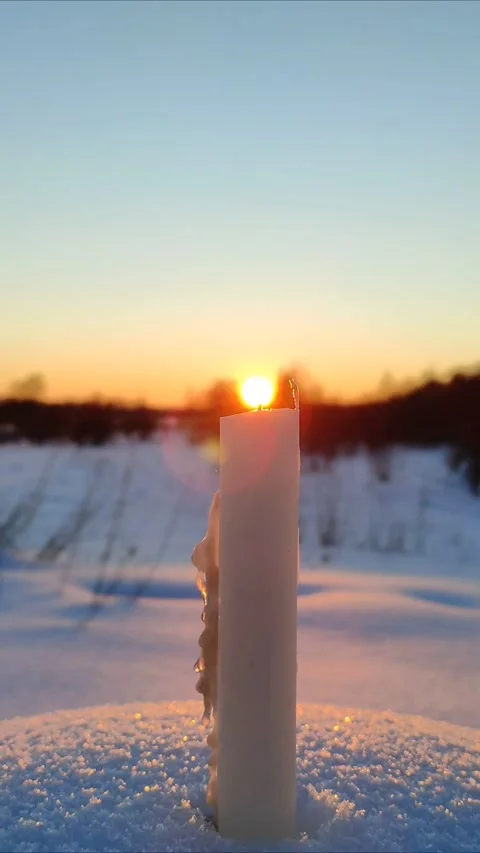 A candle burns at sunset 5 Stock Footage 327929994