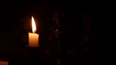 Candle cast light over skeleton figures Stock Footage 114230590