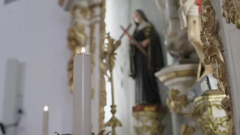 Candle on Chapel Altar Before Blurred Saint Statue 動画素材 347125045