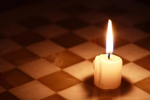 Candle On Chessboard Stock Photos