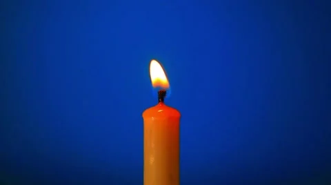Candle close-up on a blue background Video stock 56753789