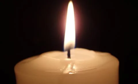 Candle on a dark background Stock Photos