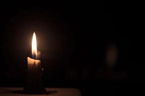 Candle in the dark background Stock Photos