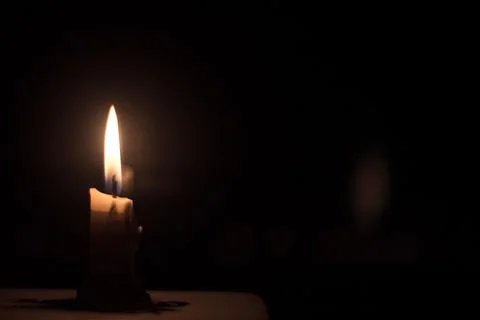 Candle in the dark background Stock Photos