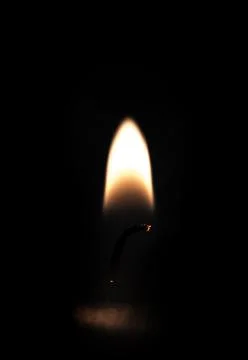 Candle on a dark background. Stock Photos