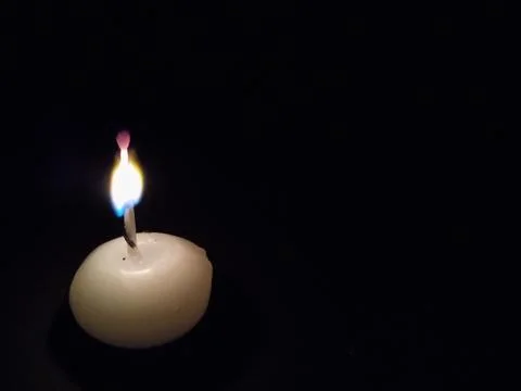 Candle in a dark background Stock Photos