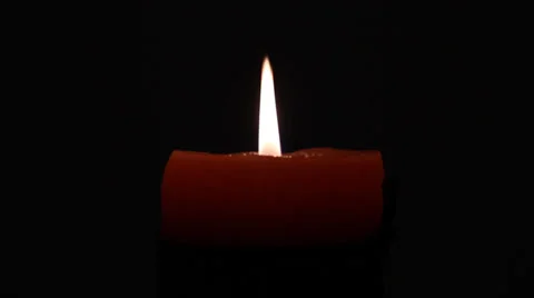 A candle in the dark. Candle flame over black background with copyspace. Stock Footage 34361310