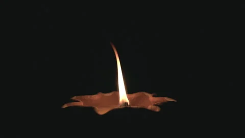 Candle in the dark, warm candlelight flame with smoke. Stock Footage 336999061