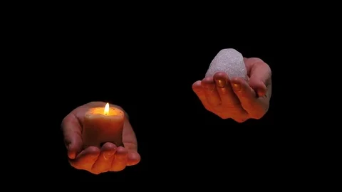 Candle fire and ice in balancing hands on black background Stock Footage 72891967
