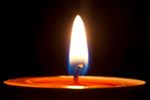 Candle fire on a black background. Stock Photos