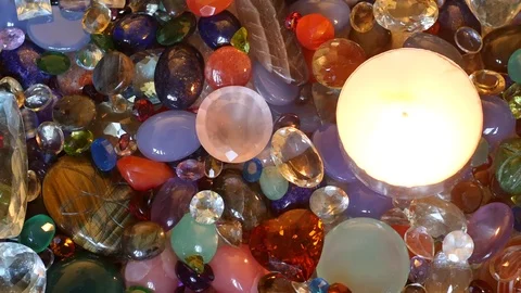 Candle fire burning among sparkling precious gemstones Stock Footage 76120195