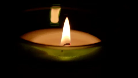 A candle fire stands at night in dark on a black background and revolves Stock Footage 152469995