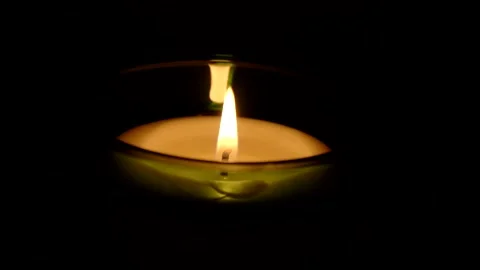 A candle fire stands at night in dark on a black background and revolves Stock Footage 152470003