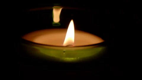 A candle fire stands at night in dark on a black background and revolves Stock Footage 152470160
