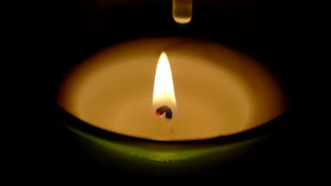 A candle fire stands at night in dark on a black background and revolves Stock Footage 152470188