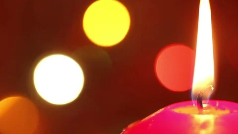 Candle flame against the background of a blinking garland. christmas background. Stock Footage 81166314