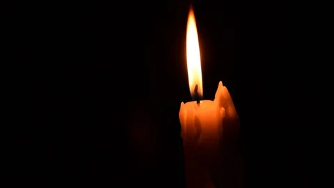 Candle flame against black background Stock Footage 76617026