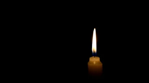 Candle flame on black background. The concept of mourning, grief or sorrow. 動画素材 101696948
