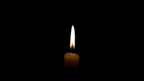 Candle flame on black background. The concept of mourning, grief or sorrow. 動画素材 101696986