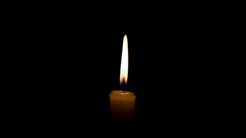 Candle flame on black background. The concept of mourning, grief or sorrow. 動画素材 101697057