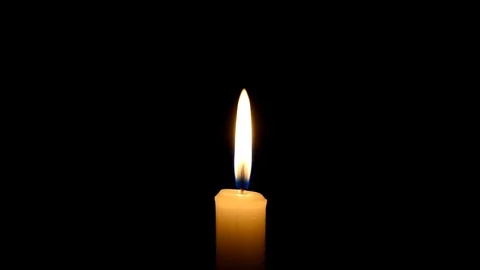 Candle flame on black background. The concept of mourning, grief or sorrow. 動画素材 101697148
