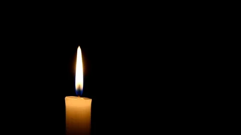 Candle flame on black background. Old yellow candle in the dark. 動画素材 101697256