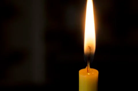 Candle flame on a black background. Stock Photos