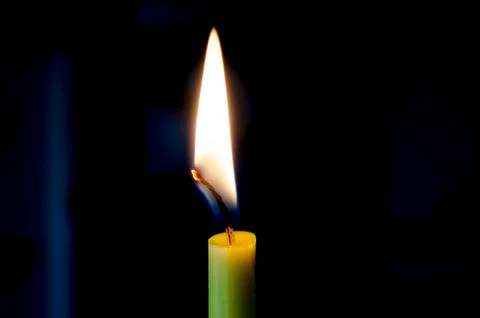 Candle flame on a black background. Stock Photos