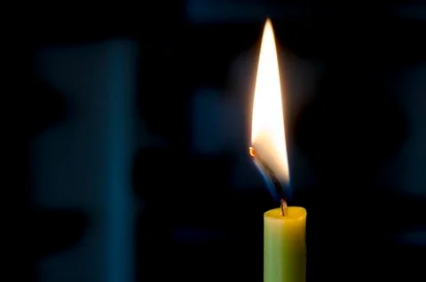 Candle flame on a black background. Stock Photos