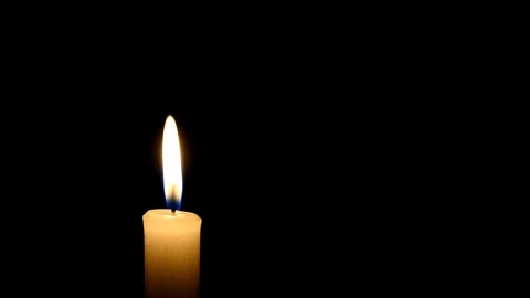 Candle flame on black background. The wind is blowing on the candle flame. 動画素材 101697286