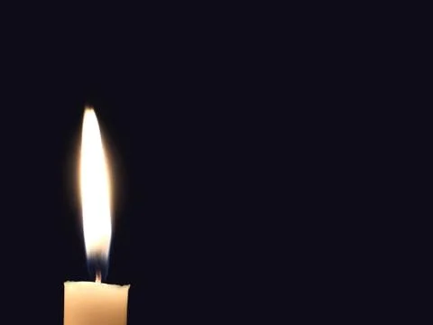 Candle flame on black empty background Foto stock