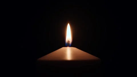 Candle flame burns in dark Stock Footage 308732199