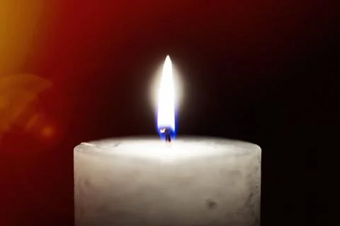 Candle flame close-up on a black background. Stock Photos