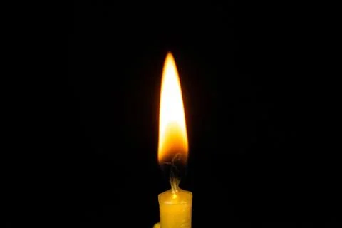Candle flame close on black background Stock Photos