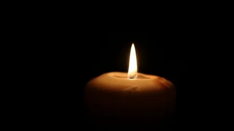 Candle flame close up burn on dark Stock Footage 98761921