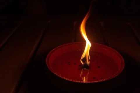Candle flame close up on dark background, interesting flame figure, candle fire Stock Photos